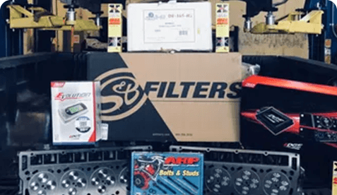 A box of filters and other items on the back of a truck.