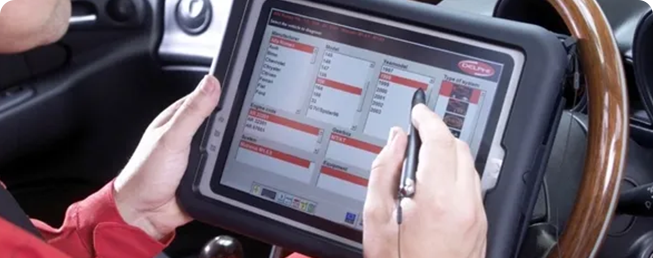 A person using a tablet computer in the car.