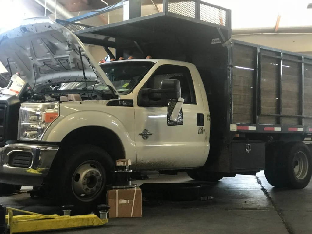 A white truck is parked in the garage