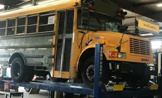 A school bus is parked in the garage.