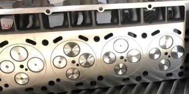 A close up of the cylinder head of an engine.